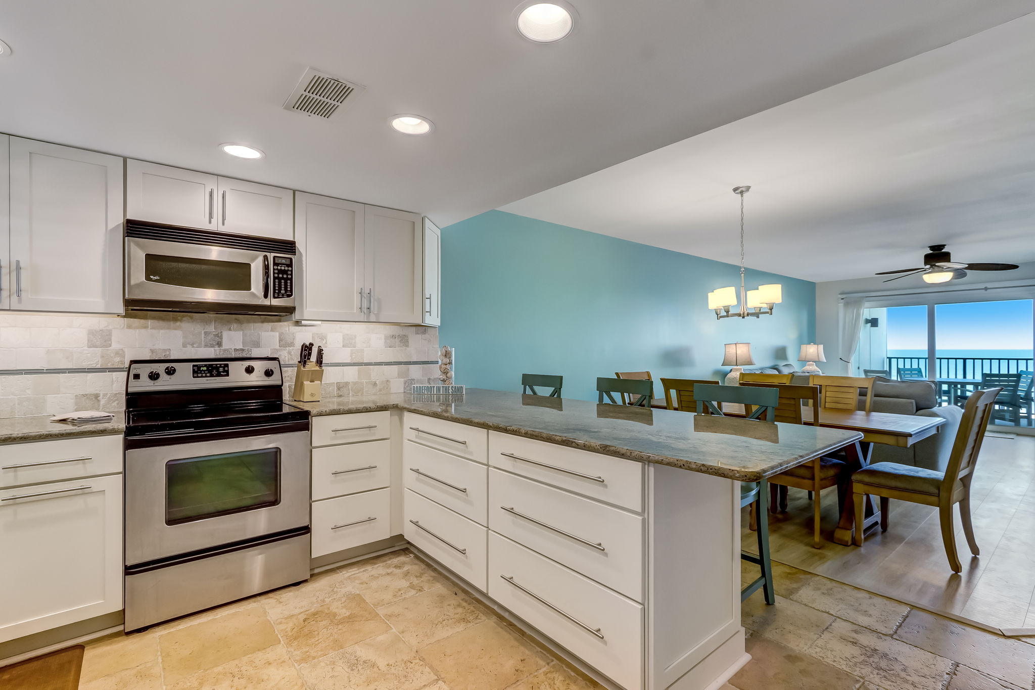 Renovated kitchen with granite counters and ocean view